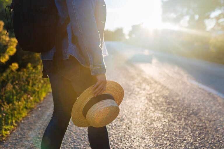 Person walking on a road, starting a journey.